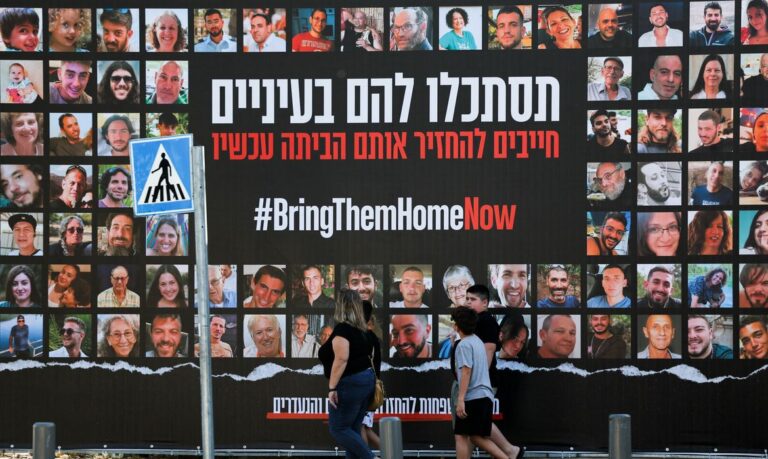 People walk past an installation which shows the pictures of hostages taken by Palestinian Islamist group Hamas following a deadly infiltration of Israel by Hamas gunmen from the Gaza Strip on October 7, before some of them are due to be released as part of a deal between Israel and Hamas to free hostages held in Gaza in exchange for the release of Palestinian prisoners, in Jerusalem, November 24, 2023 REUTERS/Ronen Zvulun