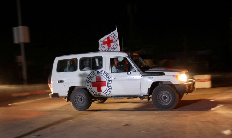 A Red Cross vehicle, as part of a convoy believed to be carrying hostages abducted by Hamas militants during the October 7 attack on Israel, arrives at the Rafah border, amid a hostages-prisoners swap deal between Hamas and Israel, in southern Gaza Strip November 24, 2023. REUTERS/Ibraheem Abu Mustafa