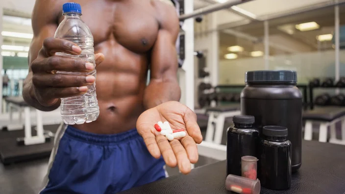 justica Wavebreakmedia/iStock via Getty Images Plusshirtless taking pill at gym 844092542