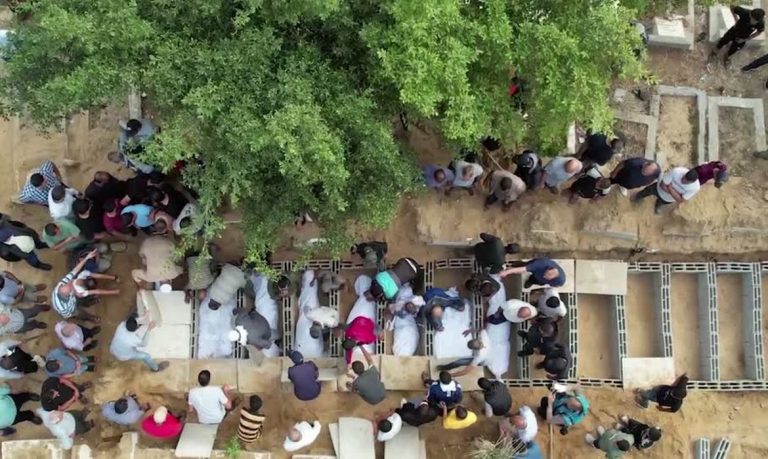 Palestinians bury 11 dead bodies in a cemetery in Gaza City