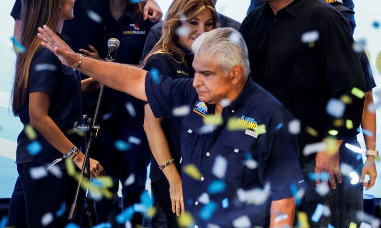 Presidential candidate Jose Raul Mulino waves on stage as his wife Marisel Cohen de Mulino looks towards him after he was declared the winner of the presidential election based on preliminary results by the electoral authority, in Panama City, Panama, May 5, 2024. REUTERS/Daniel Becerril     TPX IMAGES OF THE DAY