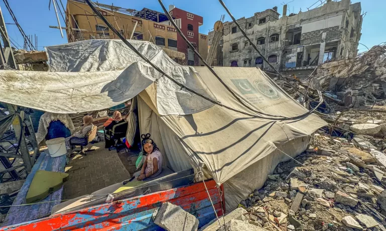 A displaced Palestinian girl, who fled her house due to Israel's military offensive, sits outside her family's tent, in Rafah, in the southern Gaza Strip May 13, 2024. REUTERS/Mohammed Salem