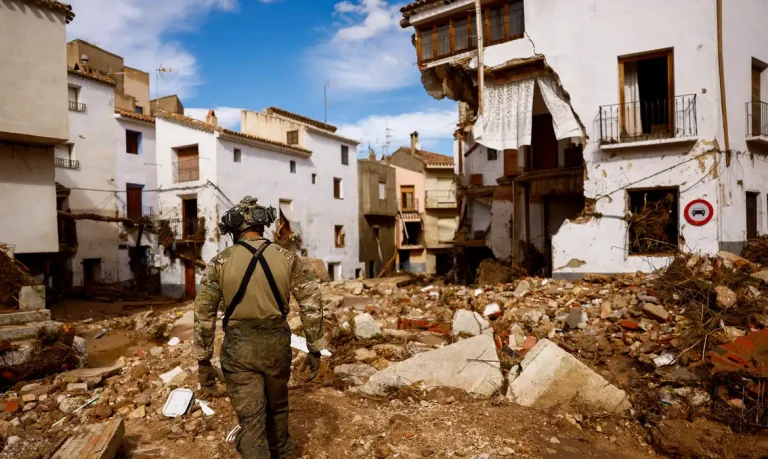 A member of Spanish UME military unit walks on the debris after heavy rains caused flooding, in Letur, Spain, October 30, 2024. REUTERS/Susana Vera