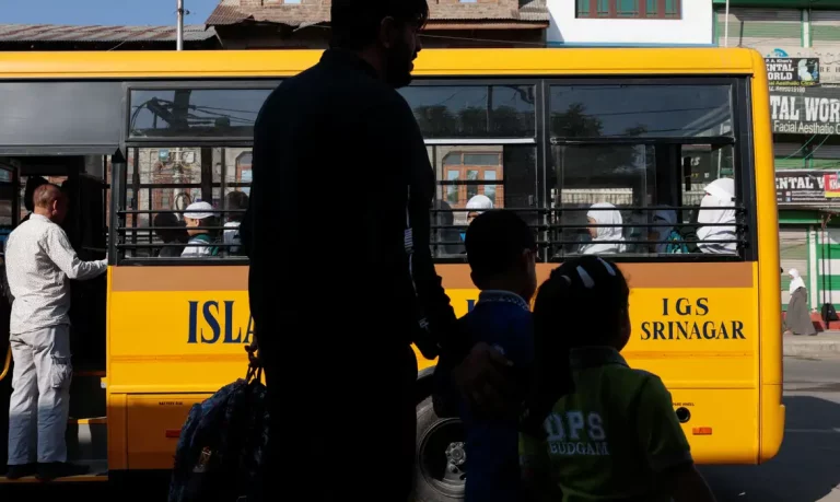 Schoolchildren wait for the bus as schools reopen following the ceasefire announcement between India and Pakistan, in Srinagar, Indian Kashmir, May 13, 2025. REUTERS/Sharafat Ali
