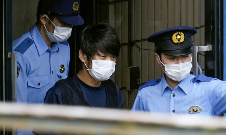 Tetsuya Yamagami, suspected of killing former Japanese premier Shinzo Abe, is escorted by police officers as he is taken to prosecutors, at Nara-nishi police station in Nara, western Japan, in this photo taken by Kyodo July 10, 2022. Mandatory credit Kyodo via REUTERS ATTENTION EDITORS - THIS IMAGE WAS PROVIDED BY A THIRD PARTY. MANDATORY CREDIT. JAPAN OUT. NO COMMERCIAL OR EDITORIAL SALES IN JAPAN. NO RESALES. NO ARCHIVES