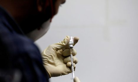 FILE PHOTO: A medic fills a syringe with COVAXIN, an Indian government-backed experimental COVID-19 vaccine, before administering it to a health worker during its trials, in Ahmedabad