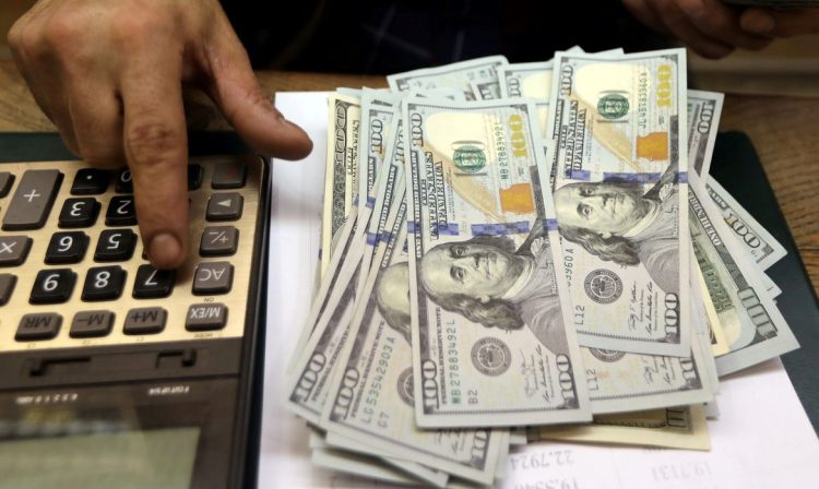 Funcionário de casa de câmbio do Cairo conta notas de dólar