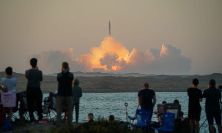 People watch as SpaceX's next-generation Starship spacecraft atop its powerful Super Heavy rocket lifts off from the company's Boca Chica launchpad on an uncrewed test flight, as seen from South Padre Island, near Brownsville, Texas, U.S. November 18, 2023. REUTERS/Go Nakamura