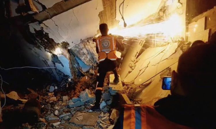 A screen grab taken from a video posted on social media by the Palestinian Civil Defence on December 5, 2023, shows what they say are members of the Palestinian Civil Defence rescue team working in a collapsed building in a location given as Gaza. Palestinian Civil Defence/Handout via REUTERS    THIS IMAGE HAS BEEN SUPPLIED BY A THIRD PARTY. MANDATORY CREDIT. NO RESALES. NO ARCHIVES.