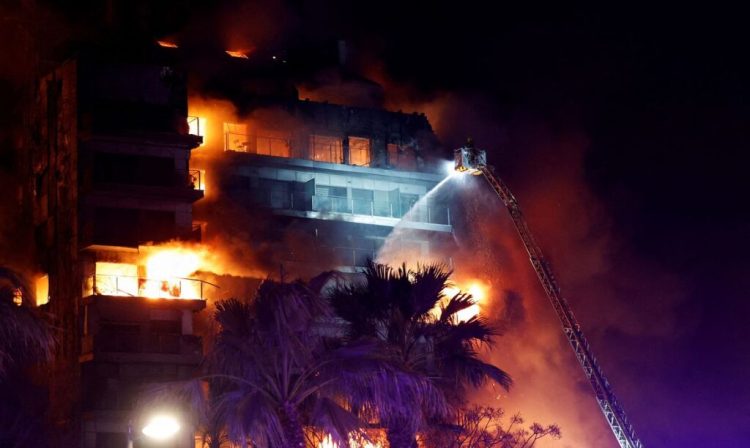 Firefighters work at the scene of a fire at an apartment building in Valencia, Spain February 22, 2024. REUTERS/Eva Manez     TPX IMAGES OF THE DAY