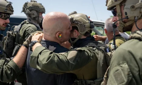 Shlomi Ziv, speaks with an Israeli soldier, after the military said that Israeli forces have rescued four hostages alive from the central Gaza Strip, in Ramat Gan, Israel, in this handout image obtained by Reuters on June 8, 2024. Israeli Army/Handout via Reuters  THIS IMAGE HAS BEEN SUPPLIED BY A THIRD PARTY