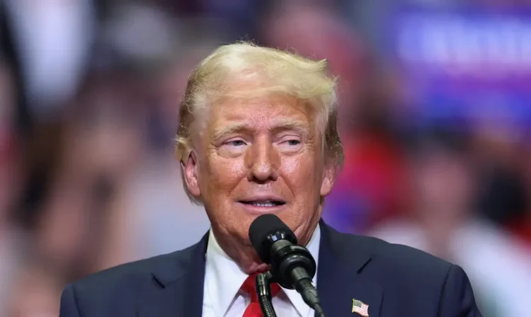 Republican presidential nominee and former U.S. President Donald Trump wears a flesh-colored bandage on his ear as he holds a campaign rally for the first time with his running mate, Republican vice presidential nominee U.S. Senator J.D. Vance (R-OH) in Grand Rapids, Michigan, U.S. July 20, 2024. REUTERS/Tom Brenner