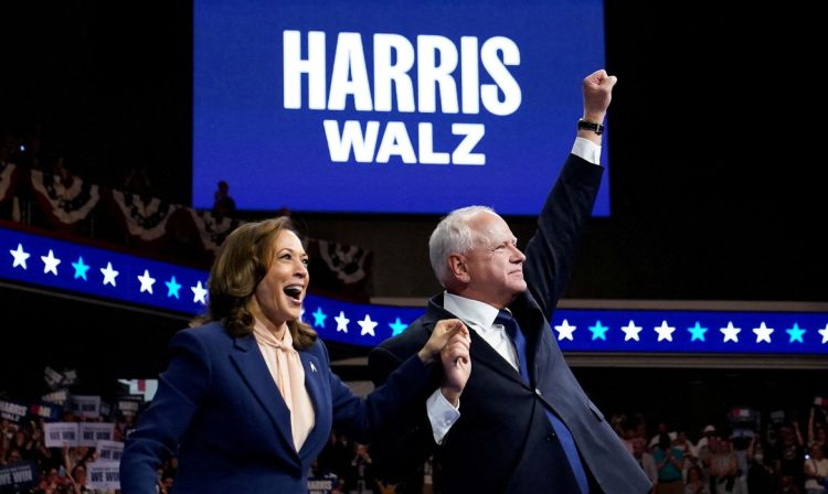 U.S. Vice President and Democratic presidential candidate Kamala Harris and her newly chosen vice presidential running mate Minnesota Governor Tim Walz react as they hold a campaign rally in Philadelphia, Pennsylvania, U.S., August 6, 2024. REUTERS/Elizabeth Frantz     TPX IMAGES OF THE DAY