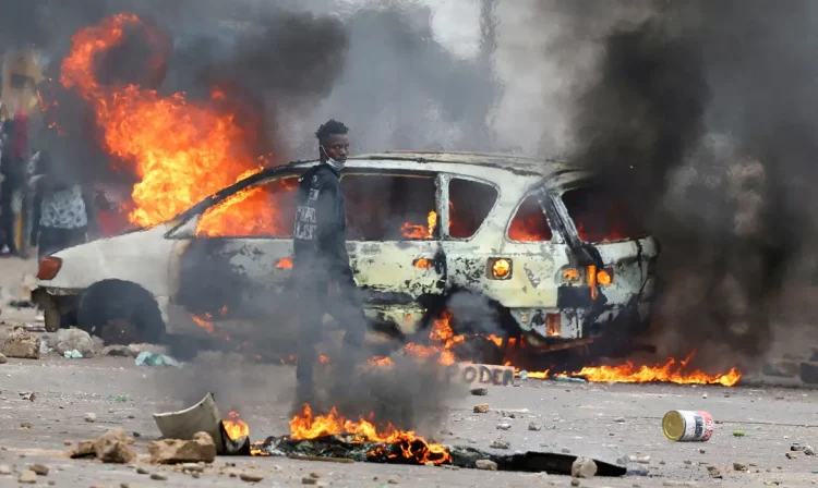 FILE PHOTO: A protester looks on near a burning barricade during a