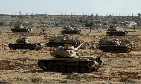 Egyptian military vehicles hold a position, near the Rafah border crossing between Egypt and the Gaza Strip, amid a ceasefire between Israel and Hamas, in Rafah, Egypt January 19, 2025. REUTERS/Mohamed Abd El Ghany
