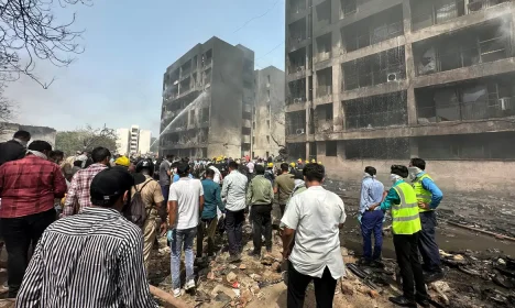 People gather near the site where an Air India plane crashed in Ahmedabad, India, June 12, 2025. REUTERS/Amit Dave