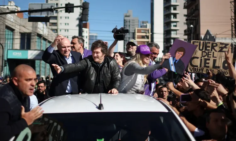 Argentina's President Javier Milei gestures at supporters, while standing on a vehicle with General Secretary of the Presidency of Argentina Karina Milei and Jose Luis Espert to attend a La Libertad Avanza party rally, ahead of legislative elections in the province of Buenos Aires, in Lomas de Zamora on the outskirts of Buenos Aires, Argentina, August 27, 2025. REUTERS/Agustin Marcarian