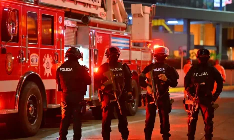 Police officers stand guard at the site where a vehicle exploded outside a shopping mall, as a second vehicle containing explosives was found nearby, but did not detonate and was immediately neutralized, according to Ecuador's Interior Minister John Reimberg, in Guayaquil, Ecuador October 14, 2025. REUTERS/Vicente Gaibor del Pino