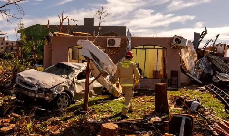 A military firefighter walks next to a house, destroyed by the tornado that hit Rio Bonito do Iguacu, in southern Parana state, Brazil November 9, 2025. REUTERS/Priscila Ribeiro