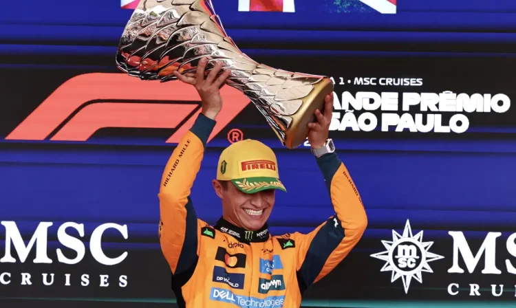 Formula One F1 - Sao Paulo Grand Prix - Autodromo Jose Carlos Pace, Sao Paulo, Brazil - November 9, 2025 McLaren's Lando Norris celebrates on the podium with a trophy after winning the Sao Paulo Grand Prix REUTERS/Jean Carniel