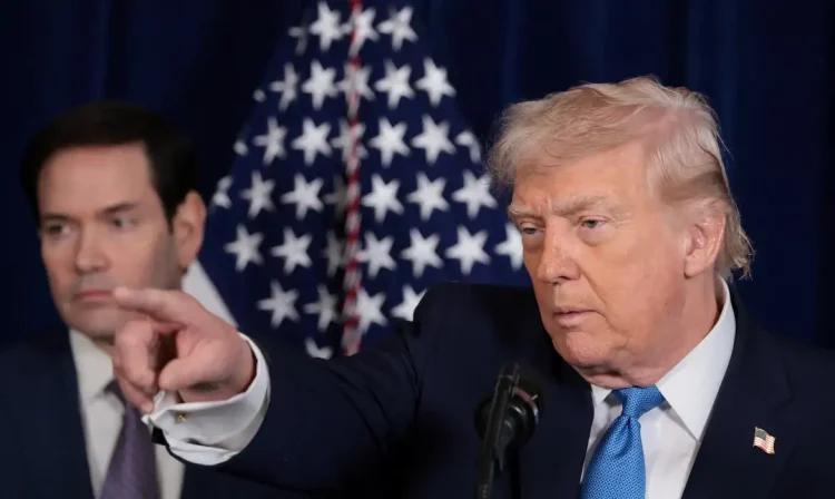 U.S. President Donald Trump points as U.S. Secretary of State Marco Rubio looks on during a press conference following a U.S. strike on Venezuela where President Nicolas Maduro and his wife, Cilia Flores, were captured, from Trump's Mar-a-Lago club in Palm Beach, Florida, U.S., January 3, 2026. REUTERS/Jonathan Ernst