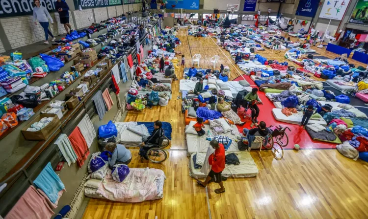 People who have been evacuated from flooded areas rest at a gym used as a shelter in Porto Alegre, Rio Grande do Sul state, Brazil May 10, 2024. REUTERS/Diego Vara