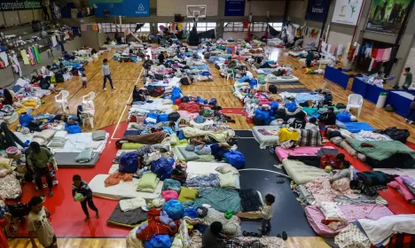 People who have been evacuated from flooded areas rest at a gym used as a shelter in Porto Alegre, Rio Grande do Sul state, Brazil May 10, 2024. REUTERS/Diego Vara