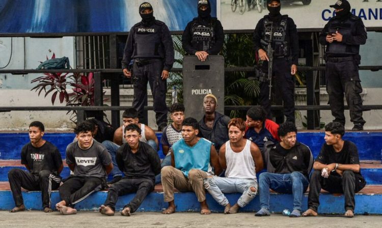 Police officers present the detainees who stormed the TC Television studio during a live TV broadcast amid the ongoing wave of violence around the nation, in Guayaquil, Ecuador January 10, 2024. REUTERS/Vicente Gaibor del Pino     TPX IMAGES OF THE DAY