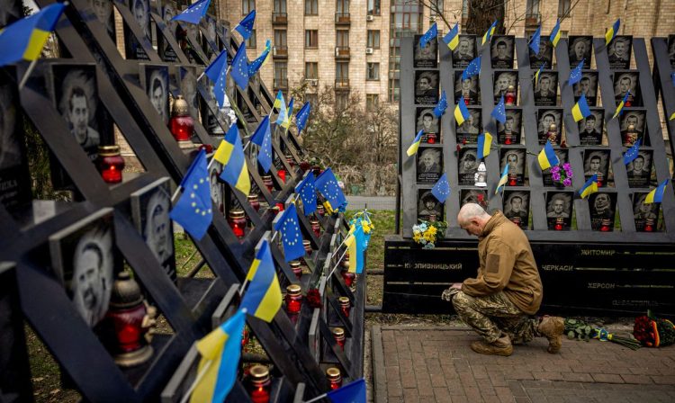 A soldier pays his respects at the monument to the so-called